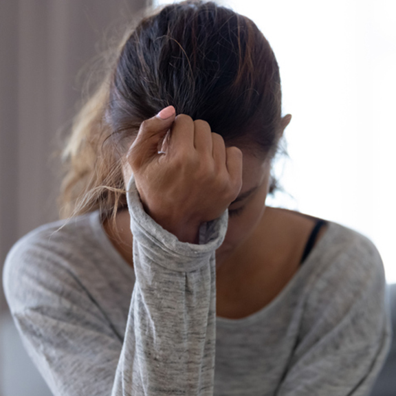 girl with her hand on her forehead