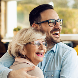 two people hugging and smiling